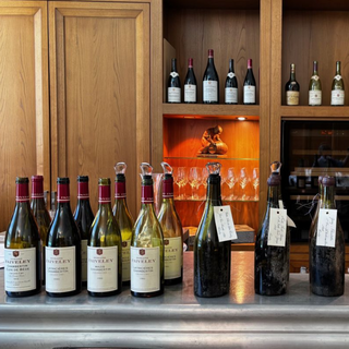 A lineup of Domaine Faiveley wine bottles, including Mazis-Chambertin and Corton-Charlemagne.