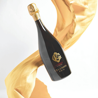 A bottle of Champagne Gosset Celebris Brut floating against a white background, with flowing gold fabric behind it.