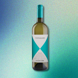 Blue-hued gradient background with an overlaid bottle of Ca’Marcanda Vistamare.