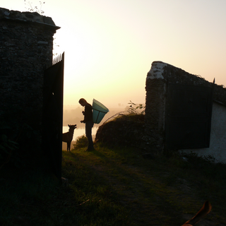 Silhouette-style profile of Virginie Joly looking down at her dog.