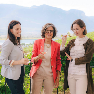 Photo of fourth-generation Elena Walch standing outdoors with her daughters, Karoline Walch and Julia Walch, with Elena in the middle flanked by the two sisters.