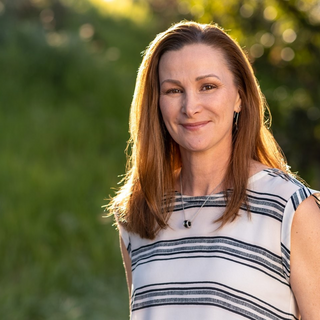 A professional photo of Gayle Bartscherer, who has brown shoulder-length hair.