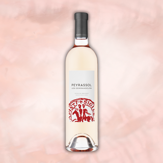 A graphic featuring Peyrassol's Les Commandeurs Rosé front and center with a light pink/beige textured background.