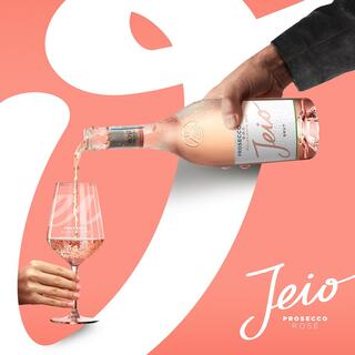An ad featuring a bottle of Jeio Prosecco Rosé being poured into a glass.